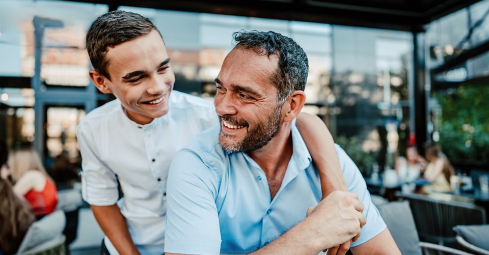 Father and son celebrating Father's Day at a restaurant